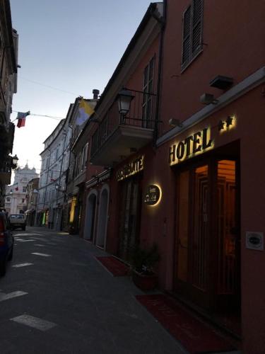 a street with a hotel sign on the side of a building at Hotel Loreto in Loreto