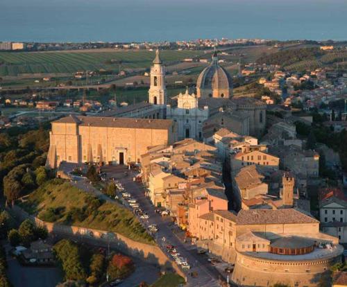 an aerial view of a city with a large building at Hotel Loreto in Loreto
