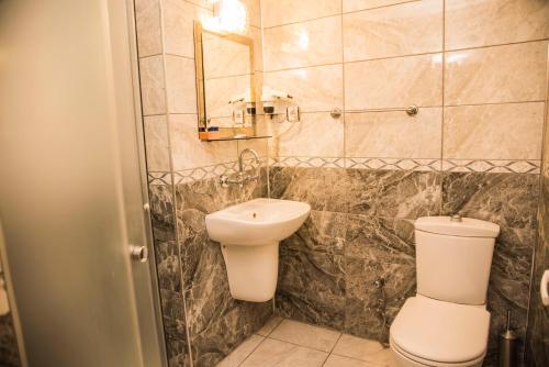 a bathroom with a toilet and a sink at Nazar Hotel in Trabzon