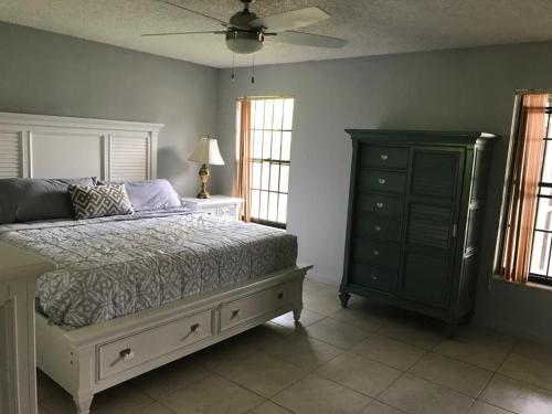 a bedroom with a bed and a dresser and windows at 82-10SW 135AV in Miami