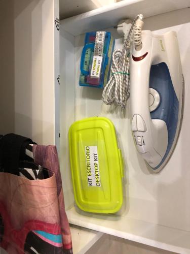 a shelf with a toothbrush and a hair dryer at BADAROSA House10min to BARCELONA City&NearTo BEACH in Badalona