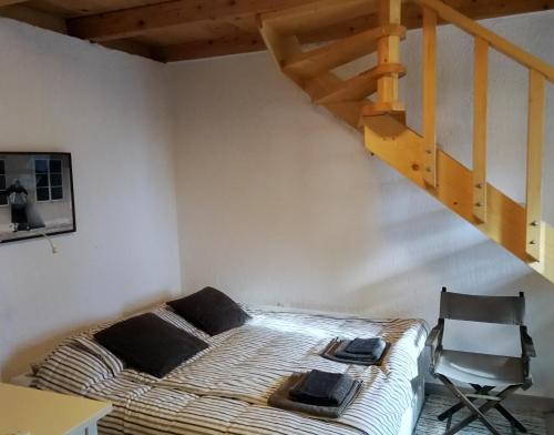 a bedroom with a bed and a staircase at House Kaja in Jablanac