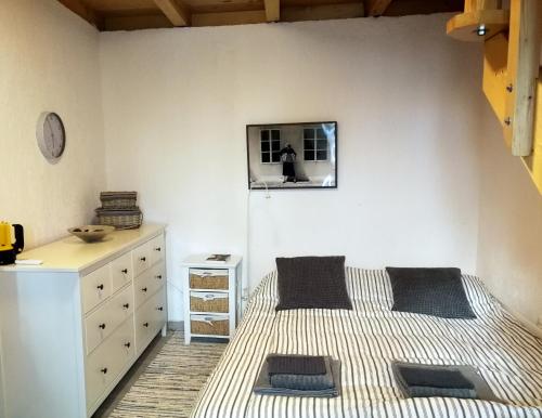 a bedroom with a bed and a dresser at House Kaja in Jablanac