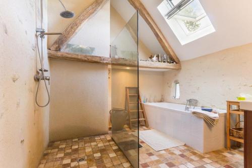 a bathroom with a bath tub and a sink at La Thibaude - Livry in Livry