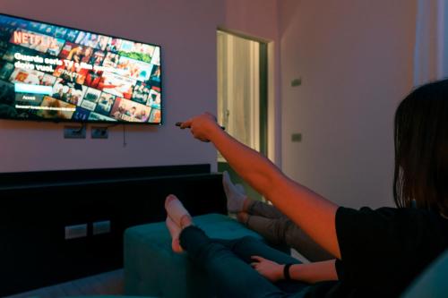 a woman sitting on a couch playing a video game at Alla Riva in Verona