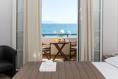 a hotel room with a bed and a view of the ocean at Anesis Hotel in Agia Pelagia Kythira