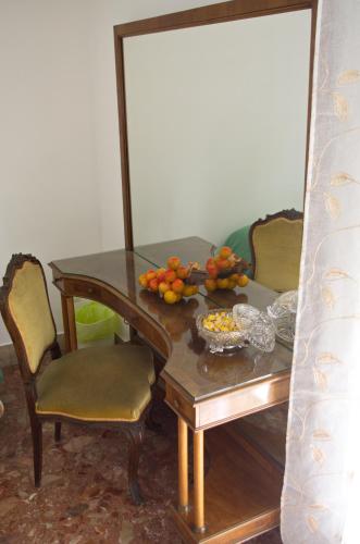 a dining room table with a bowl of fruit on it at Olivarooms in Palermo