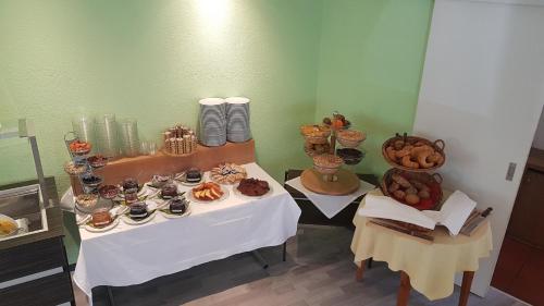 a table with a bunch of food on it at Hotel Alpha Thun in Thun