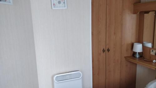 a room with a heater in the corner of a room at Sealands Ingoldmells 6 Berth Panel heated Baysdale in Ingoldmells