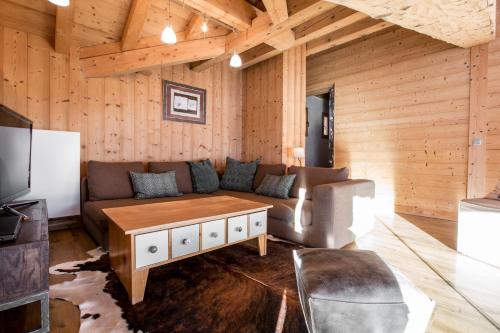a living room with a couch and a table at Le Grand Canyon in Les Gets