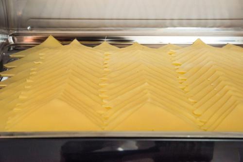 a pan filled with yellow food in an oven at Anesis Hotel in Agia Pelagia Kythira