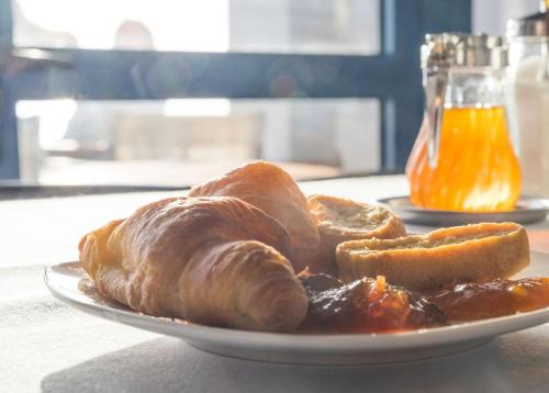 a plate of croissants and other food on a table at Anesis Hotel in Agia Pelagia Kythira