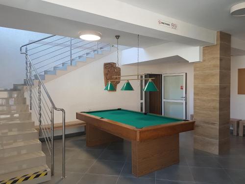 a pool table in a room with a staircase at O.W.W Janosik in Ustronie Morskie