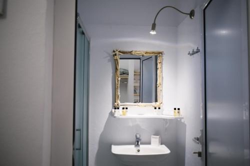 a bathroom with a sink and a mirror at Filia Bungalow in Archangelos
