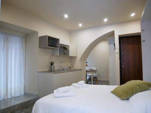 a bedroom with a bed with two towels on it at Vuciata Apartments in Catania