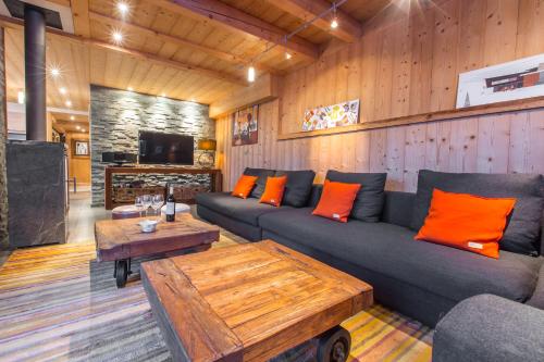 a living room with a couch and a table at Le Grand Canyon in Les Gets