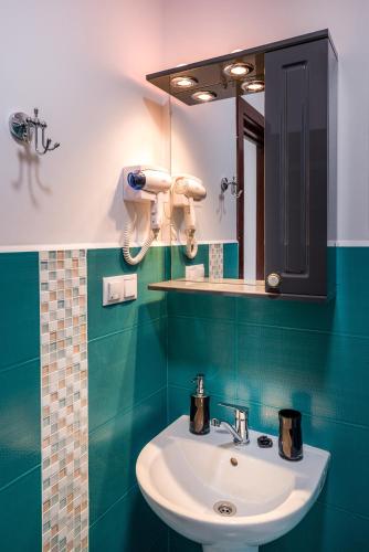 a bathroom with a sink and a mirror at Casa Sorriso in Turda