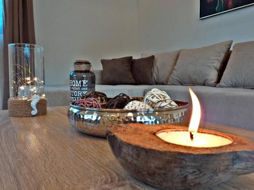 a living room with a table with a candle on it at Nicole Luxury Villas in Koskinou