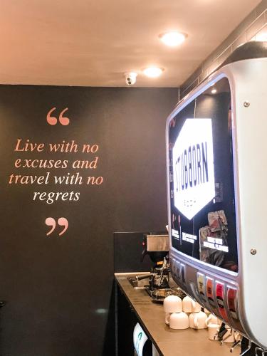 a kitchen with a sign on a wall with a television at Red Sands Hotel in Torrey