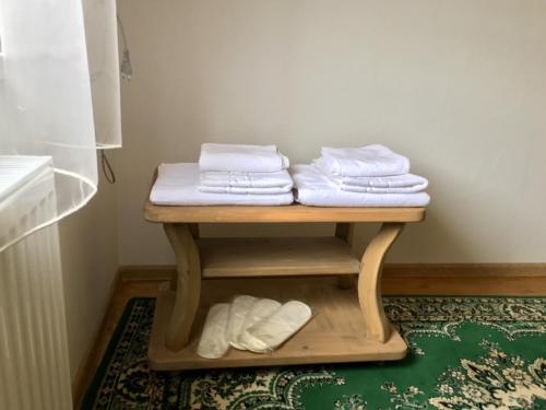 a table with three folded towels on top of it at Шале на зарінку in Izki