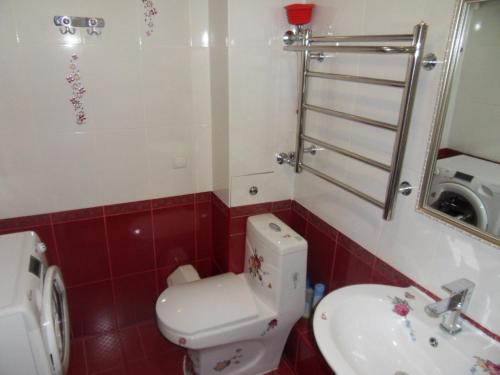a bathroom with a toilet and a sink at Карасай Батыра 108 in Almaty