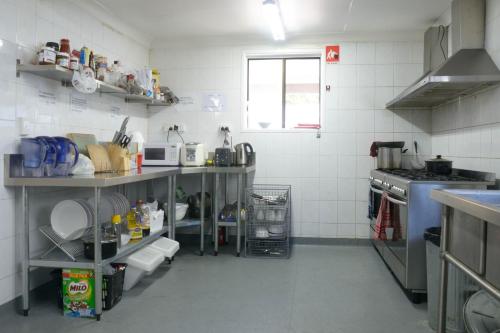 a small kitchen with a counter and a sink at Gonow Family Backpackers Hostel in Brisbane