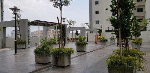 a courtyard with potted trees in a building at Strait Garden Suites X Ace Pro @ George Town in Jelutong