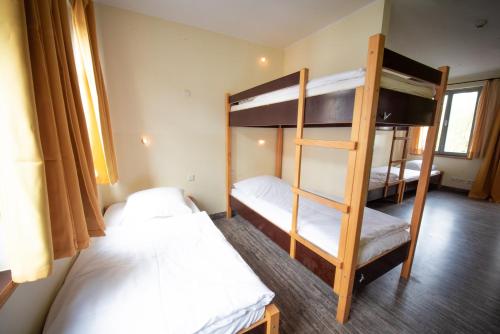 a room with two bunk beds and a ladder at Backpackers St. Pauli in Hamburg