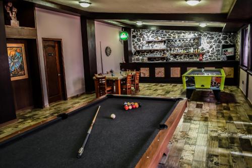 a billiard room with a pool table and a bar at The Latit Hotel Querétaro in Querétaro