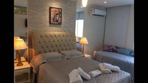 a bedroom with two beds with towels on them at Copaestilo in Rio de Janeiro
