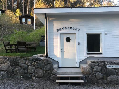 a white building with a door and a sign on it at Duvberget in Kolmården