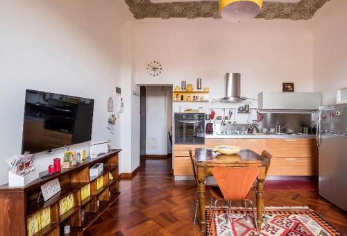 uma cozinha com uma mesa e uma geladeira em Il Cuore di Bologna em Bolonha