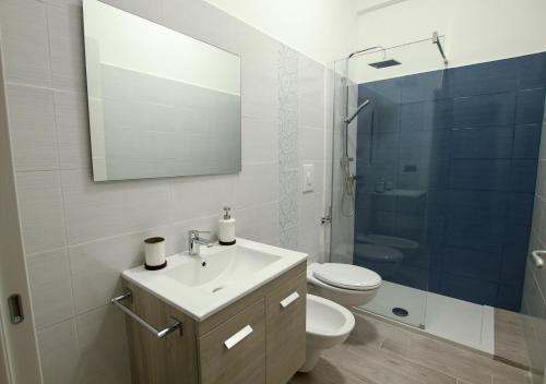 a bathroom with a sink and a toilet and a mirror at B&B Alto Salento - Pool and Sun in Pulsano