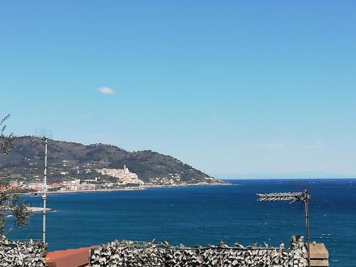 a view of the ocean with a town on a hill at 70 Via Vione in San Bartolomeo al Mare