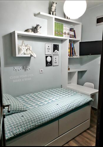 a childs bedroom with a bed and a book shelf at Apartmani vuk in Cetinje