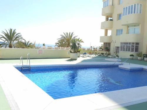 een zwembad voor een gebouw bij FANTASTIC APARTMENT B IN FRONT OF THE SEA & MARINA in Estepona