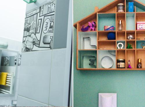 a shelf in a bathroom next to a refrigerator at Mansardine Metropolitane in Brescia
