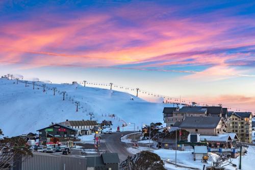 a ski resort with a ski lift on a snowy mountain at Fountains 3 in Mount Hotham