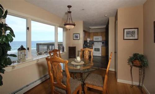 a dining room with a table and a view of the ocean at The Skylark Beach Inn in Old Orchard Beach