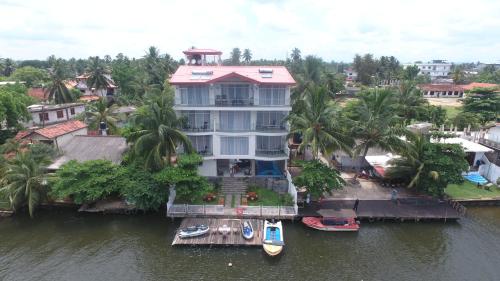 an aerial view of a large house on the water at Amber House Lanka in Bentota