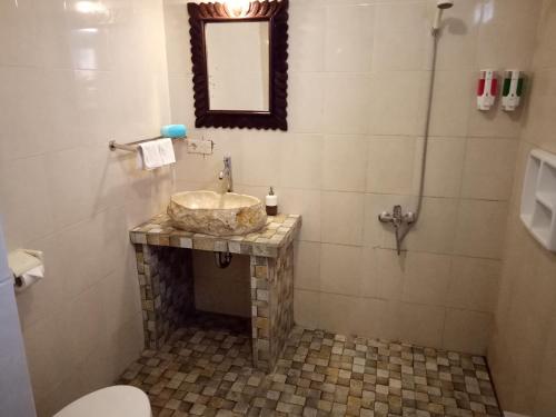 a bathroom with a sink and a shower at Atres Villa in Munduk