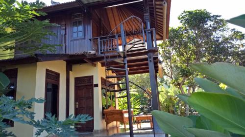 a tree house with a spiral staircase leading up to it at Atres Villa in Munduk