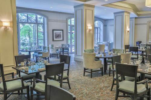 a restaurant with tables and chairs and windows at Grand Hyatt Atlanta in Buckhead in Atlanta