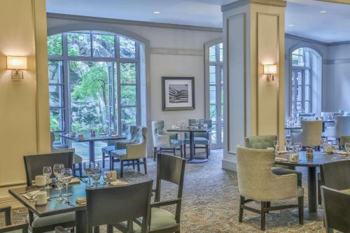 a restaurant with tables and chairs and windows at Grand Hyatt Atlanta in Buckhead in Atlanta