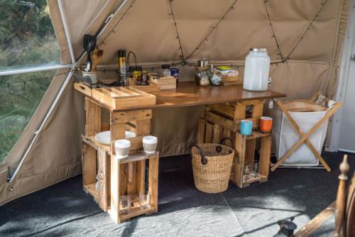 a table in a tent with a counter at Mt Gold Glamping in Wanaka