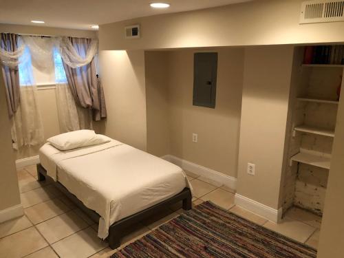 a bedroom with a bed and a book shelf at An English Gem near Union Station in Washington