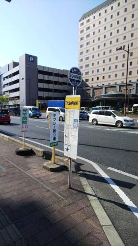 three signs on the side of a city street at リバーサイド厚生町 in Okayama