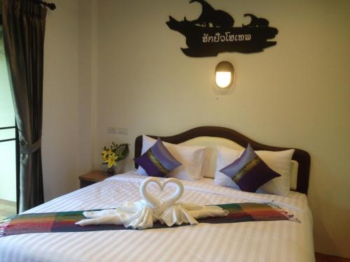 a bedroom with a bed with a heart decoration on it at Hugpua Hotel in Nan
