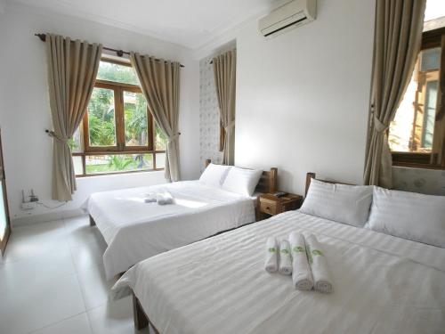 Un pat sau paturi într-o cameră la Coconut Garden Mui Ne