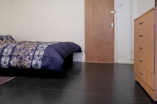 A bed or beds in a room at TEVIOT STREET - DELUXE GUEST ROOM
